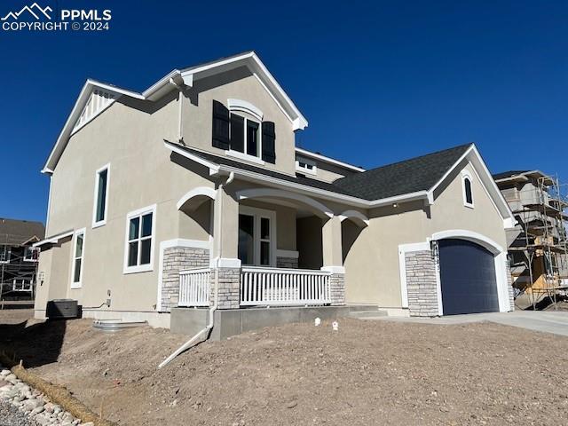 view of front of house with covered porch and a garage