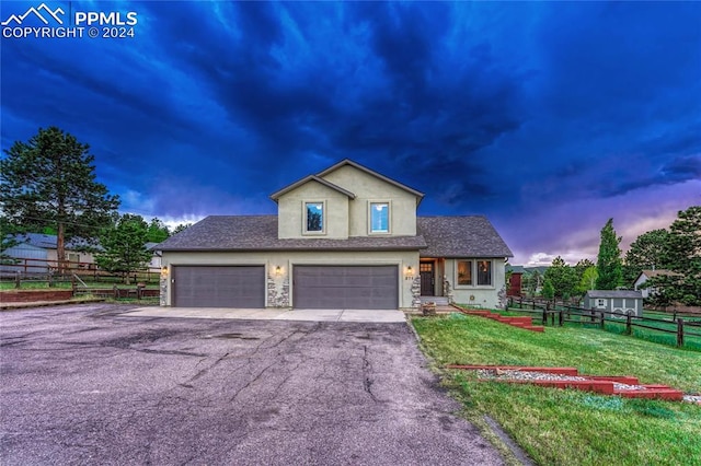 front facade with a yard and a garage