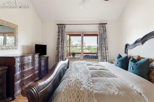 bedroom featuring lofted ceiling and light hardwood / wood-style floors