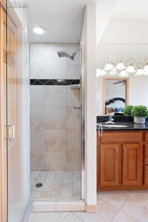 bathroom featuring an enclosed shower, vanity, and tile patterned flooring