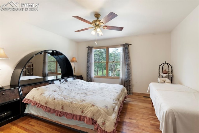 bedroom with ceiling fan and light wood-type flooring