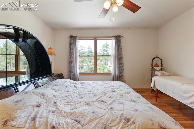 bedroom with ceiling fan and wood-type flooring