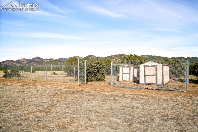 exterior space featuring a mountain view and a storage unit