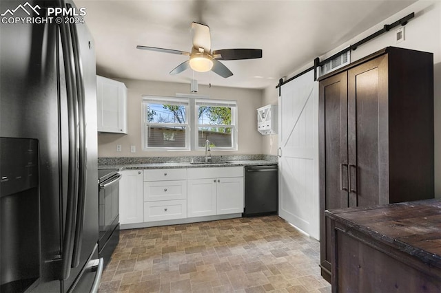 kitchen with stove, stainless steel fridge, a barn door, sink, and black dishwasher