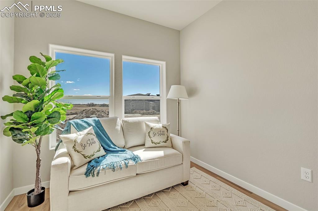 sitting room with wood finished floors and baseboards