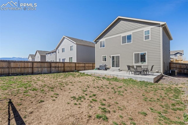 back of house featuring a patio area and central air condition unit