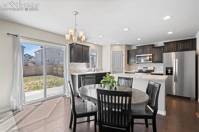 dining space featuring hardwood / wood-style flooring and a chandelier