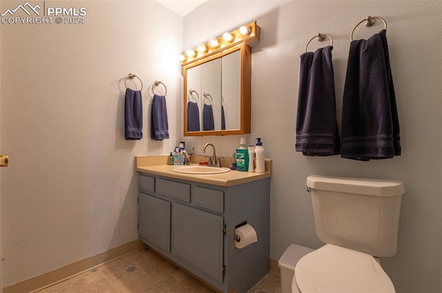 bathroom featuring vanity, toilet, and tile patterned flooring