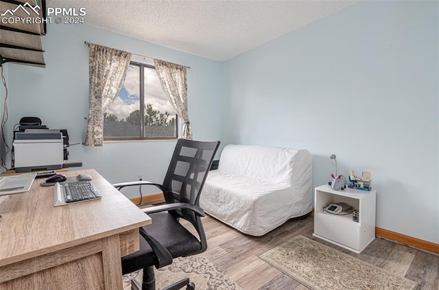 office with a textured ceiling and light hardwood / wood-style floors