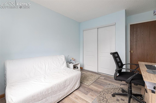 office area with a textured ceiling and hardwood / wood-style flooring