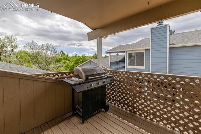 wooden terrace featuring area for grilling