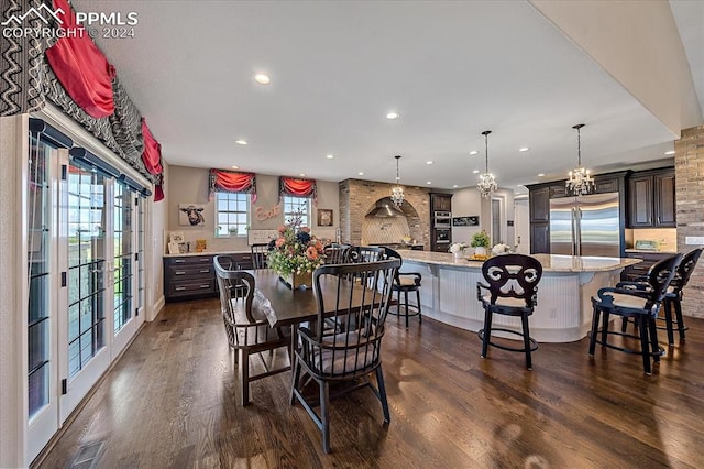 dining area featuring an inviting chandelier and dark wood-type flooring