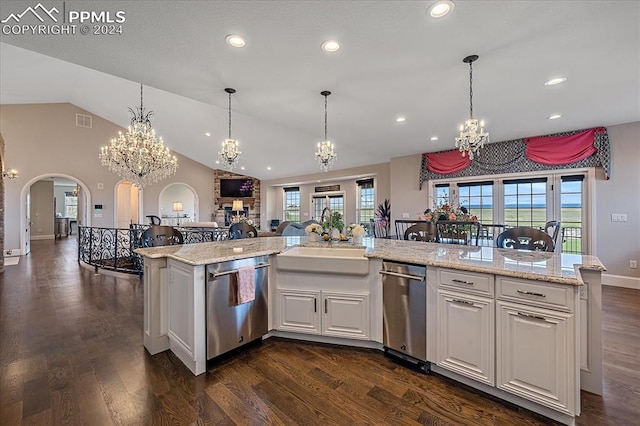 kitchen with dark hardwood / wood-style flooring, a healthy amount of sunlight, hanging light fixtures, white cabinetry, and lofted ceiling