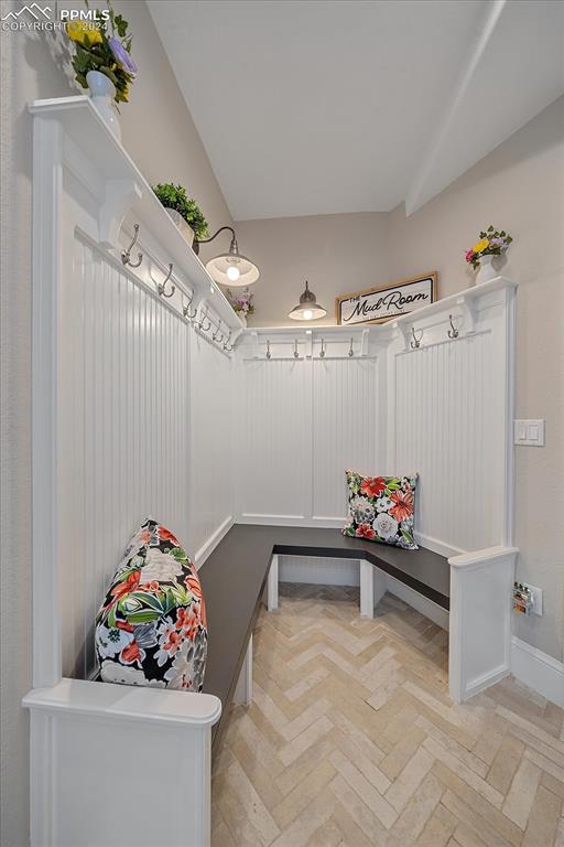 mudroom featuring lofted ceiling and light parquet flooring