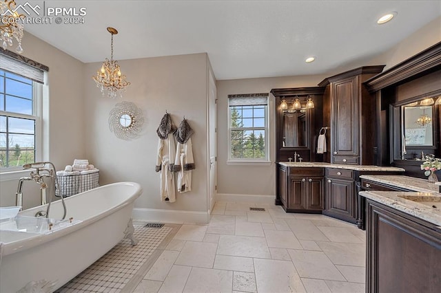 bathroom with a tub, dual vanity, tile flooring, and a wealth of natural light