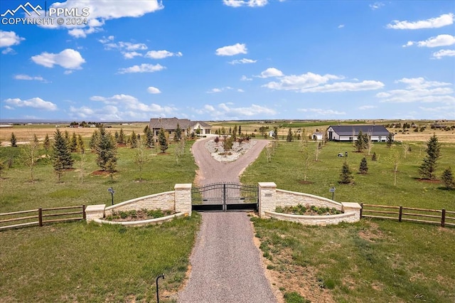 view of property's community featuring a rural view and a lawn