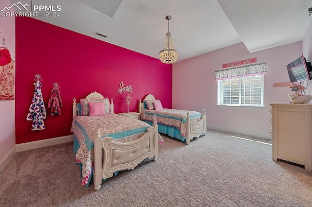 bedroom featuring carpet floors and an inviting chandelier