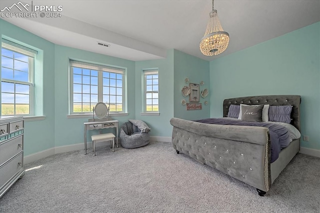 carpeted bedroom featuring a chandelier