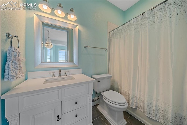 bathroom with tile flooring, toilet, and vanity