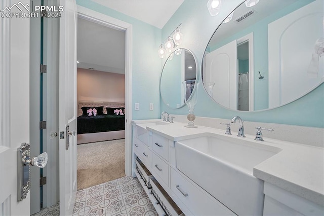 bathroom featuring double vanity and tile floors