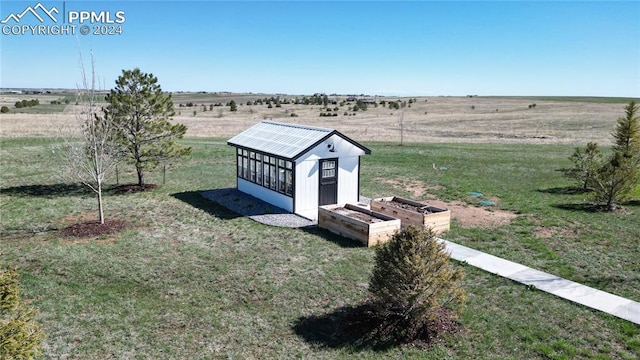 exterior space with a rural view and a lawn