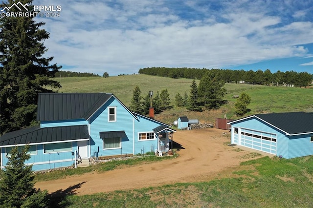 exterior space featuring a rural view and an outdoor structure