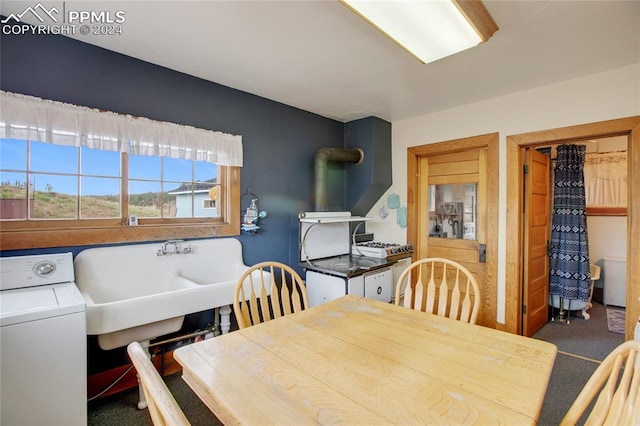 dining space with dark carpet and washer / dryer