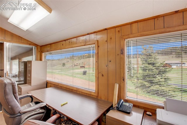 home office featuring wood walls and lofted ceiling