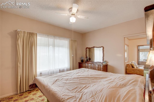 bedroom featuring a textured ceiling and ceiling fan