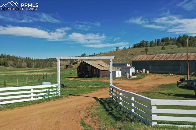 exterior space with an outdoor structure and a rural view