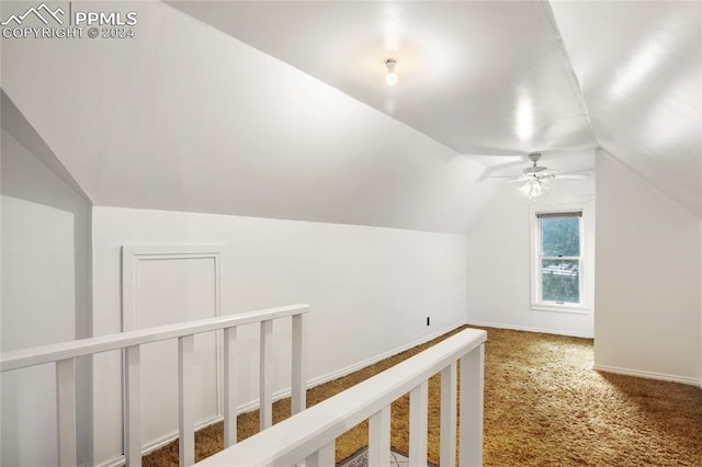 additional living space with carpet flooring, vaulted ceiling, and ceiling fan