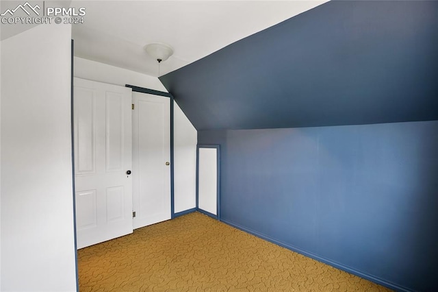 bonus room featuring lofted ceiling and carpet floors