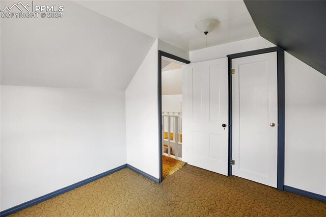 bonus room featuring carpet and vaulted ceiling