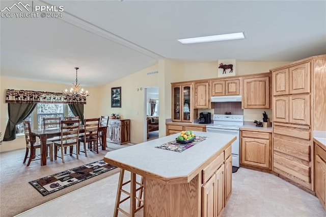 kitchen featuring vaulted ceiling with skylight, electric stove, light tile floors, and a center island