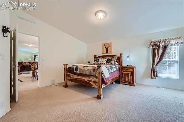 bedroom with carpet flooring and vaulted ceiling