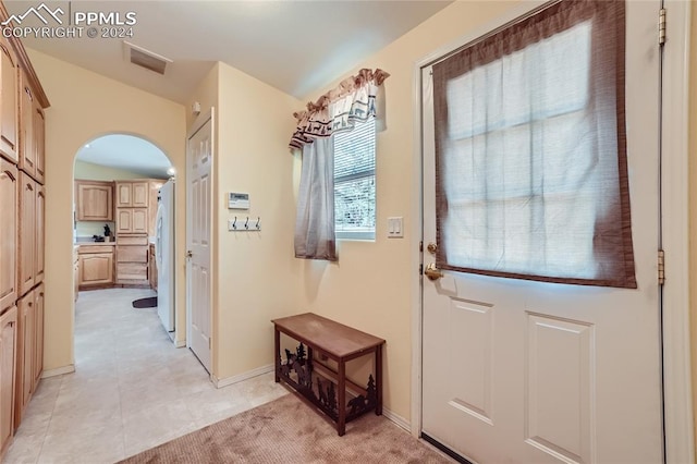 doorway featuring light tile flooring