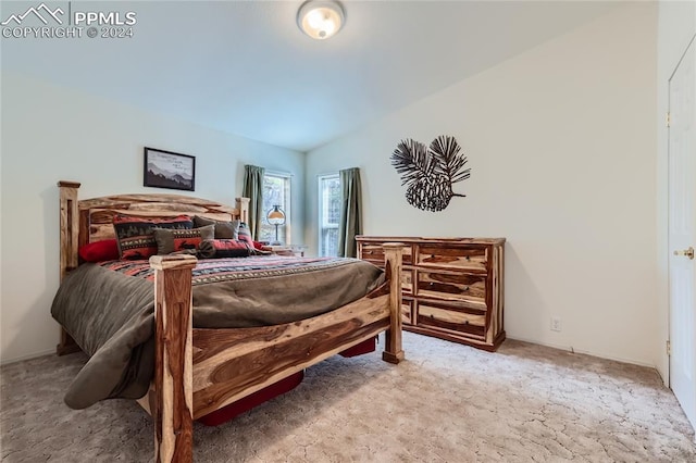 carpeted bedroom featuring lofted ceiling