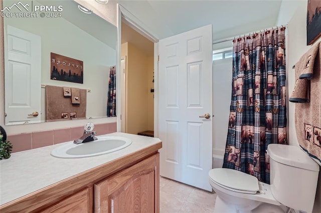 full bathroom featuring shower / bath combo with shower curtain, vanity, toilet, and tile floors