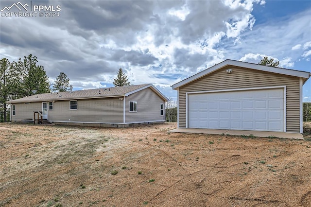 view of home's exterior featuring a garage and an outdoor structure