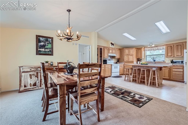 carpeted dining area with a notable chandelier and vaulted ceiling with skylight