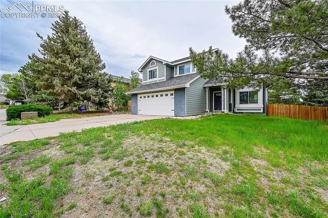 view of front of property featuring a garage and a front lawn