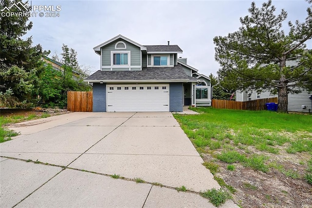 view of property with a garage and a front yard