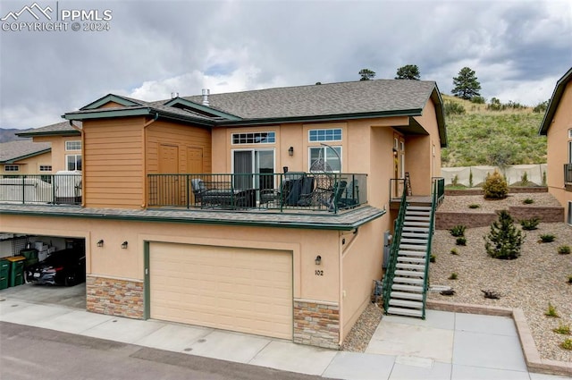 view of front facade with a balcony and a garage