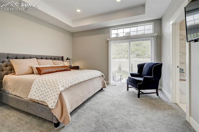 bedroom with carpet, access to outside, and a tray ceiling