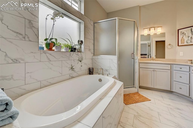 bathroom featuring plus walk in shower and vanity