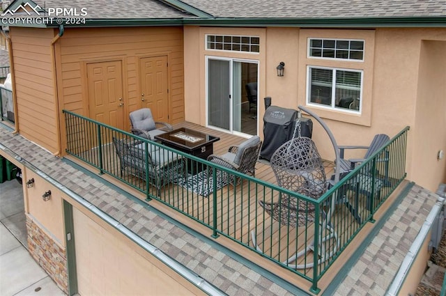 wooden terrace featuring a fire pit and grilling area