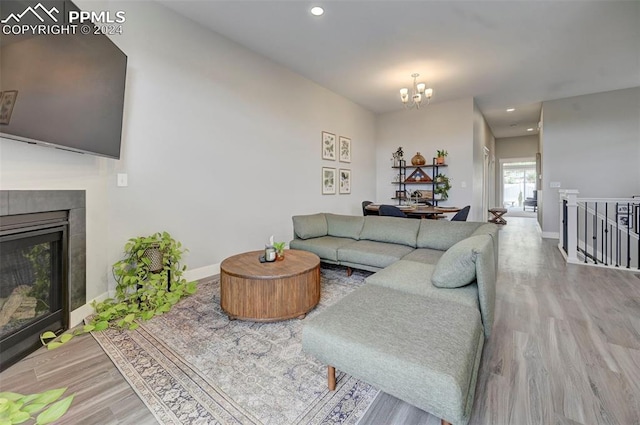 living room featuring a chandelier and wood-type flooring