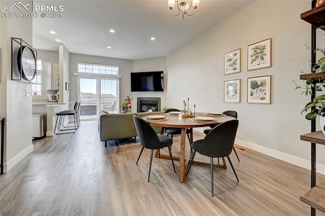 dining area with an inviting chandelier and light wood-type flooring