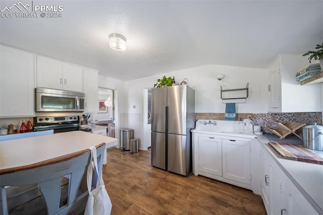 kitchen featuring sink, white cabinetry, dark wood-type flooring, and appliances with stainless steel finishes