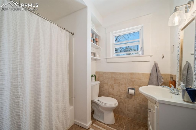 full bathroom featuring vanity, toilet, tile walls, and shower / tub combo with curtain